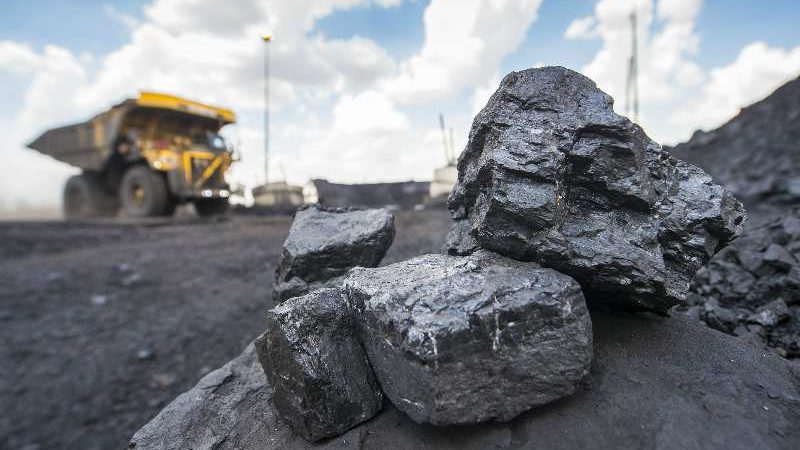 Coal rocks with mining truck in the background